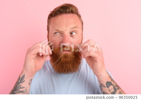 Doubter man with beard and light blue t-shirt Doubter man with beard and light blue t-shirt 96350025