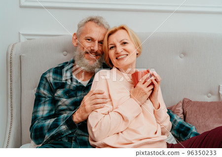husband and wife have breakfast with coffee on the bed at home husband and wife have breakfast with coffee on the bed at home 96350233