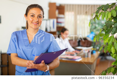 Confident woman doctor standing in office Confident woman doctor standing in office 96350234