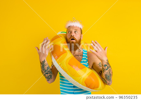 man with life buoy and princess crown feels too hot man with life buoy and princess crown feels too hot 96350235