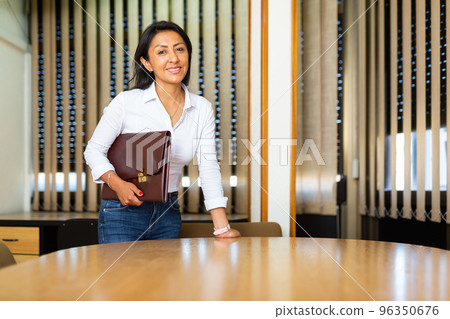 Portrait of business woman standing in office Portrait of business woman standing in office 96350676