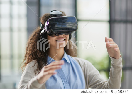positive woman wearing virtual reality goggles headsetConnection, technology, new generation, progress concept. 96350885