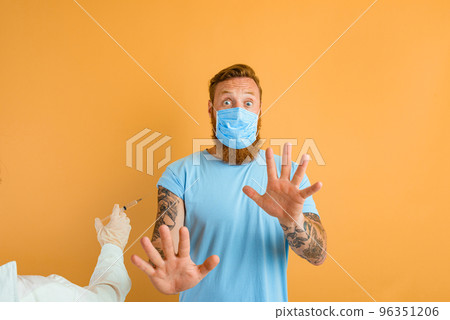 Afraid man with beard, tattoo and mask for covid-19 is ready for the virus vaccine 96351206