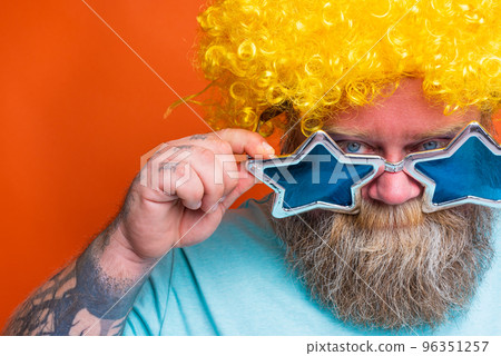 Fat thoughtful man with beard, tattoos and sunglasses has doubt about something 96351257