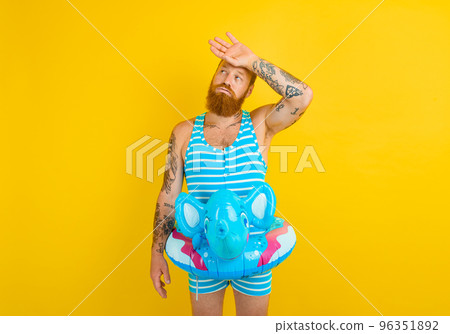 man with inflatable donut with elephant is ready to swim man with inflatable donut with elephant is ready to swim 96351892
