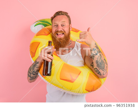 Happy man is ready to swim with a donut lifesaver with beer and cigarette in hand Happy man is ready to swim with a donut lifesaver with beer and cigarette in hand 96351938