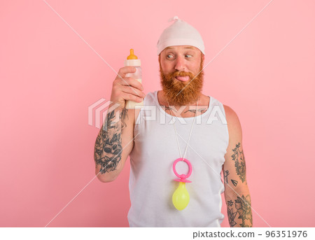 Hungry man with beard and tattoos acts like a small newborn Hungry man with beard and tattoos acts like a small newborn 96351976