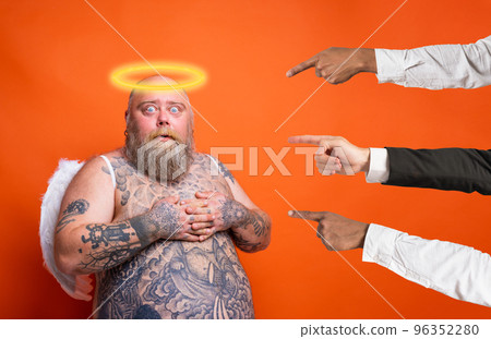 Fat afraid man with beard ,tattoos and wings acts like an angel Fat afraid man with beard ,tattoos and wings acts like an angel 96352280