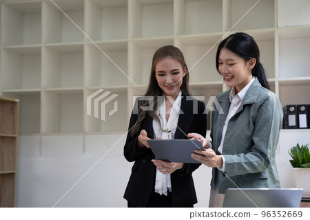 diverse coworkers working together in boardroom, brainstorming, discussing and analyzing and planning business strategy. diverse coworkers working together in boardroom, brainstorming, discussing and analyzing and planning business strategy. 96352669
