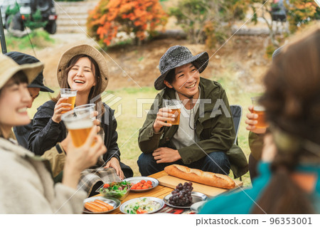 Asian men and women drinking beer and partying with friends at a campsite in autumn and winter Asian men and women drinking beer and partying with friends at a campsite in autumn and winter 96353001