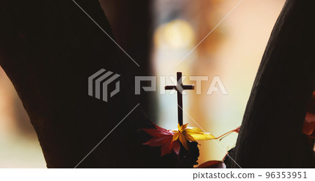 Beautiful fallen leaves and red maple leaves falling through the trees and the Holy Cross of Jesus Christ Beautiful fallen leaves and red maple leaves falling through the trees and the Holy Cross of Jesus Christ 96353951