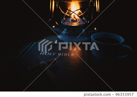 Dark night comfortable bright burning lamp and glowing holy bible and cross of Jesus Christ 96353957
