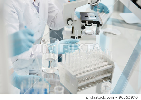 scientists conduct testing in a medical laboratory . 96353976