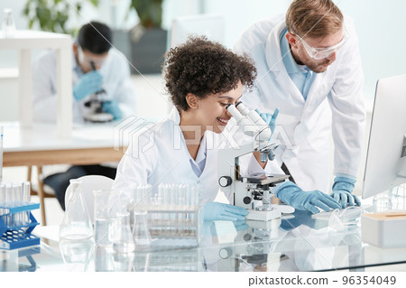 female scientist and her colleague are conducting research in the laboratory . female scientist and her colleague are conducting research in the laboratory . 96354049