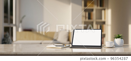 Workspace marble tabletop with tablet mockup and stuff over blurred minimal living room 96354287