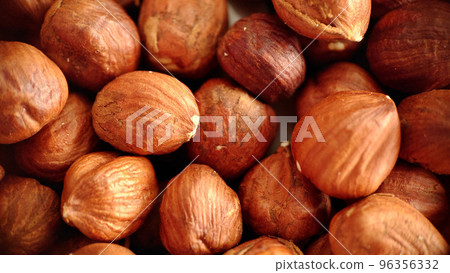 A handful of large hazelnuts close-up selective focus 96356332