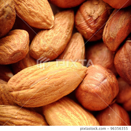 A mixture of peeled almonds and hazelnuts in close-up A mixture of peeled almonds and hazelnuts in close-up 96356355