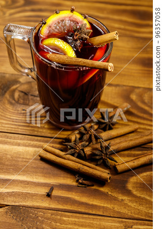 Mulled wine and spices on wooden table Mulled wine and spices on wooden table 96357058