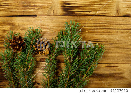 Christmas composition with fir tree branches and cones on wooden background. Top view, copy space Christmas composition with fir tree branches and cones on wooden background. Top view, copy space 96357060