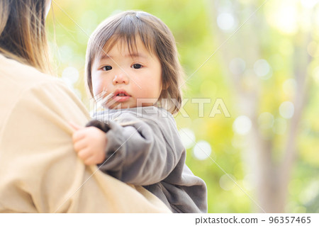 Baby being hugged by mother 96357465