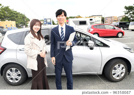 Male instructor and female student at driving school 96358087