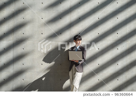 Man operating a computer while standing 96360664