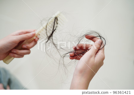 Asian woman have problem with long hair loss attach in her hand. Asian woman have problem with long hair loss attach in her hand. 96361421