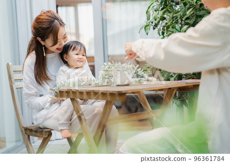 A family spending time with their baby on the terrace of their house 96361784