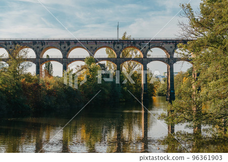 Railway Bridge with river in Bietigheim-Bissingen, Germany. Autumn. Railway viaduct over the Enz River, built in 1853 by Karl von Etzel on a sunny summer day. Bietigheim-Bissingen, Germany. Old 96361903