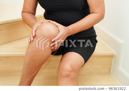 Asian senior woman wearing elastic support knee brace for reduce pain. 96361922