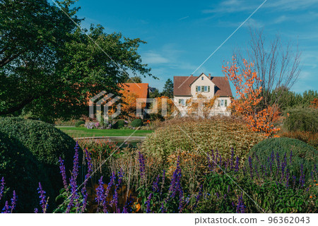 House with nice garden in fall. Flowers in the City Park of Bietigheim-Bissingen, Baden-Wuerttemberg, Germany, Europe. Autumn Park and house, nobody, bush and grenery House with nice garden in fall. Flowers in the City Park of Bietigheim-Bissingen, Baden-Wuerttemberg, Germany, Europe. Autumn Park and house, nobody, bush and grenery 96362043