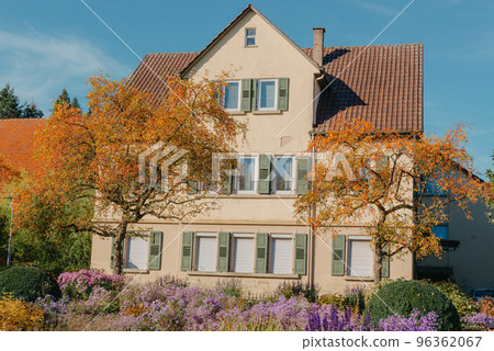 House with nice garden in fall. Flowers in the City Park of Bietigheim-Bissingen, Baden-Wuerttemberg, Germany, Europe. Autumn Park and house, nobody, bush and grenery 96362067