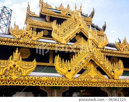 The golden square hall with a pyramidal roof castle mondop and golden tiered umbrella under the blue sky 96362125