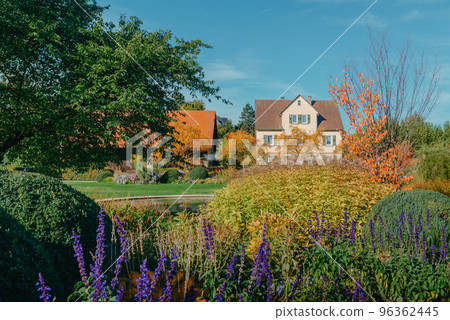 House with nice garden in fall. Flowers in the City Park of Bietigheim-Bissingen, Baden-Wuerttemberg, Germany, Europe. Autumn Park and house, nobody, bush and grenery 96362445