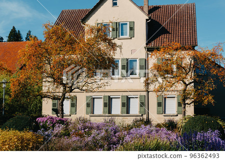 House with nice garden in fall. Flowers in the City Park of Bietigheim-Bissingen, Baden-Wuerttemberg, Germany, Europe. Autumn Park and house, nobody, bush and grenery 96362493