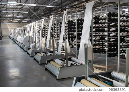 Many large coils wind ready-made propylene sleeves from woven threads for the manufacture of industrial bags. PP bag production line Many large coils wind ready-made propylene sleeves from woven threads for the manufacture of industrial bags. PP bag production line 96362891