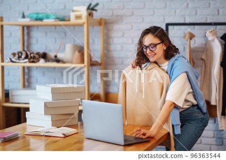 Female warehouse worker, seller, dropshipping small business owner recording new content for vlog. 96363544