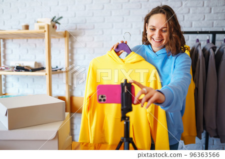 Female warehouse worker, seller, dropshipping small business owner recording new content for vlog. 96363566