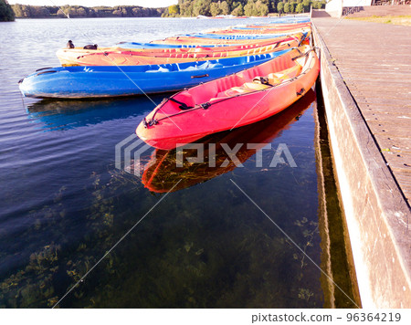 kayaks floating at a lake 96364219