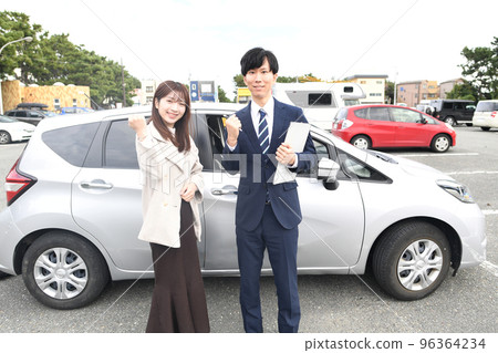 Male instructor and female student at driving school 96364234