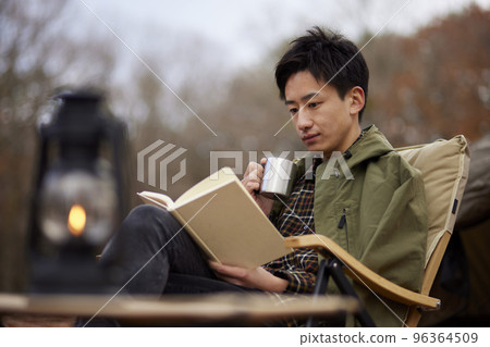 Young Japanese man enjoying solo camping 96364509