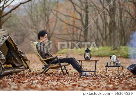 Young Japanese man enjoying solo camping 96364529