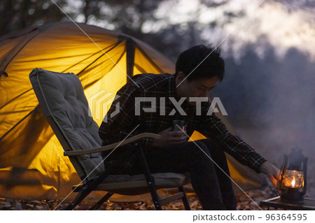Young Japanese man enjoying solo camping 96364595