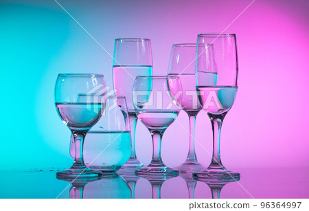 Wine glasses with neon multicolor light Wine glasses with neon multicolor light 96364997