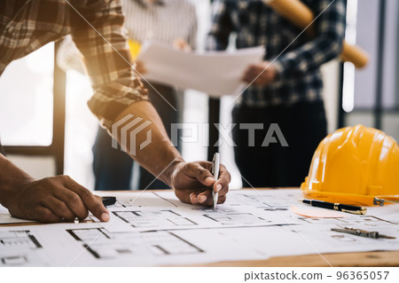 Working as a team architect and designer working on blueprint project of new apartments. Photo concept of work on technical drawings in office. Working as a team architect and designer working on blueprint project of new apartments. Photo concept of work on technical drawings in office. 96365057