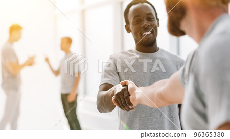 close up. successful young people shaking hands. 96365380
