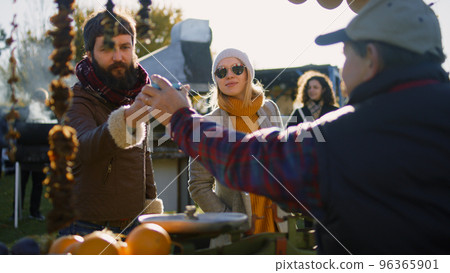 Couple buy products at farmers market Couple buy products at farmers market 96365901