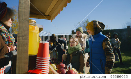 Mother with two children buying watermelon 96366023