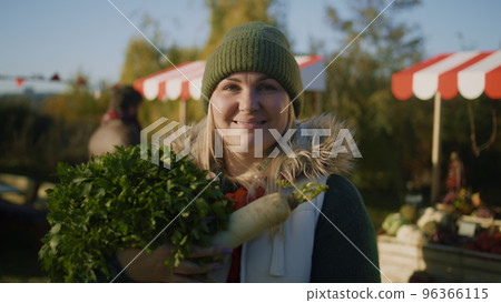 Adult woman posing with bag of fruits Adult woman posing with bag of fruits 96366115