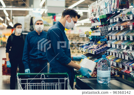 customer puts their purchases on the supermarket counter customer puts their purchases on the supermarket counter 96368142